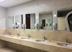 Neat and clean commercial restroom with 4 sinks and mirrors