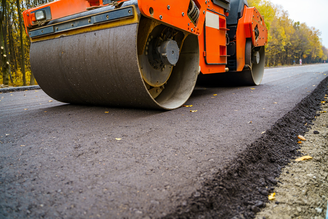 Pavement roller truck, compressing newly layed asphalt