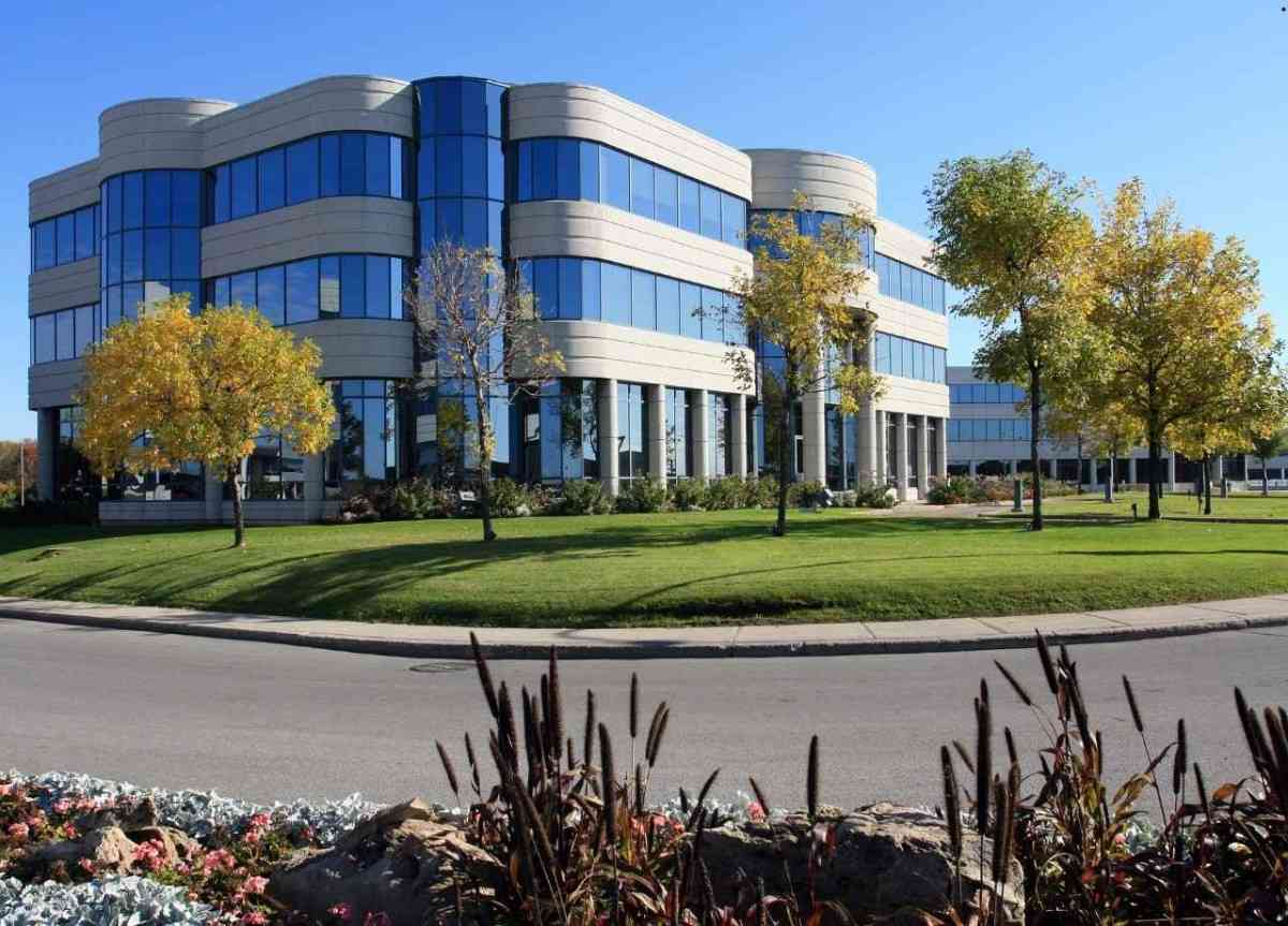 Beautiful office building with manicured lawn and well trimmed trees