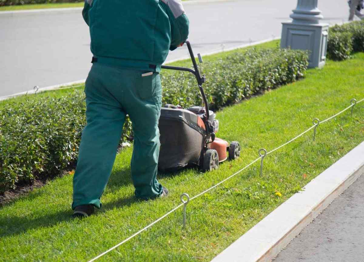 A man mowing lawn outside