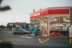 Cars parked outside convinient store parking lot