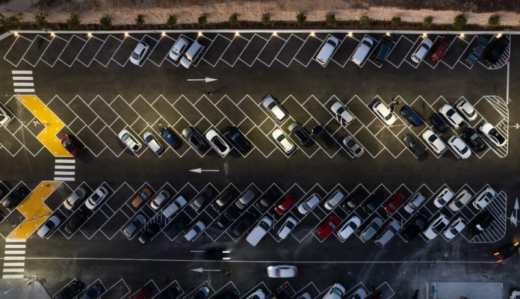 drone-aerial-view-of-parking-lots-with-cars-at-night