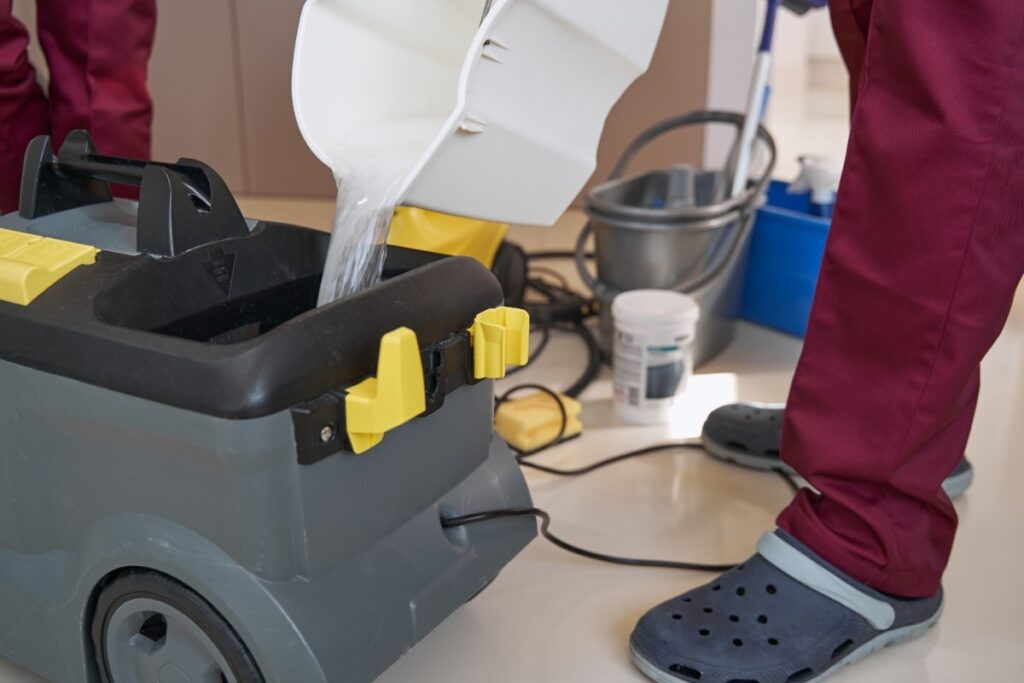 Experienced cleaner preparing equipment for wet cleaning