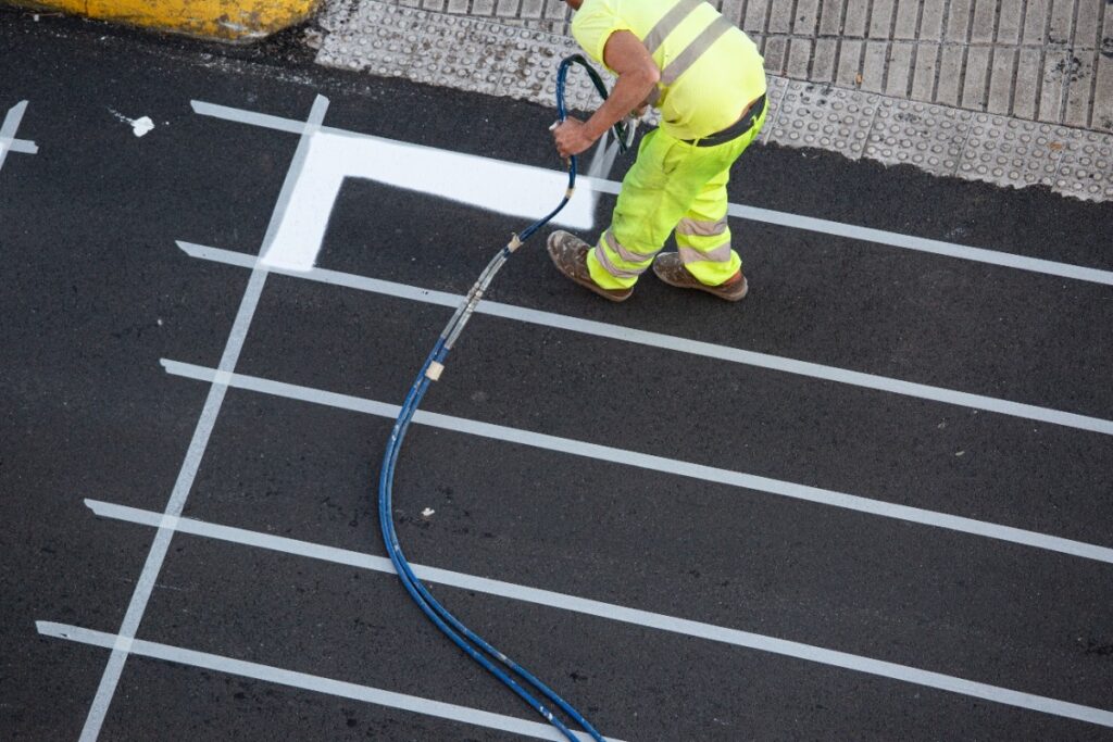 worker-painting-a-pedestrian-crosswalk-road
