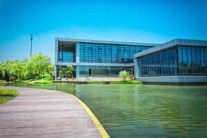 Commercial office building surrounded by water and beautiful lush greenery