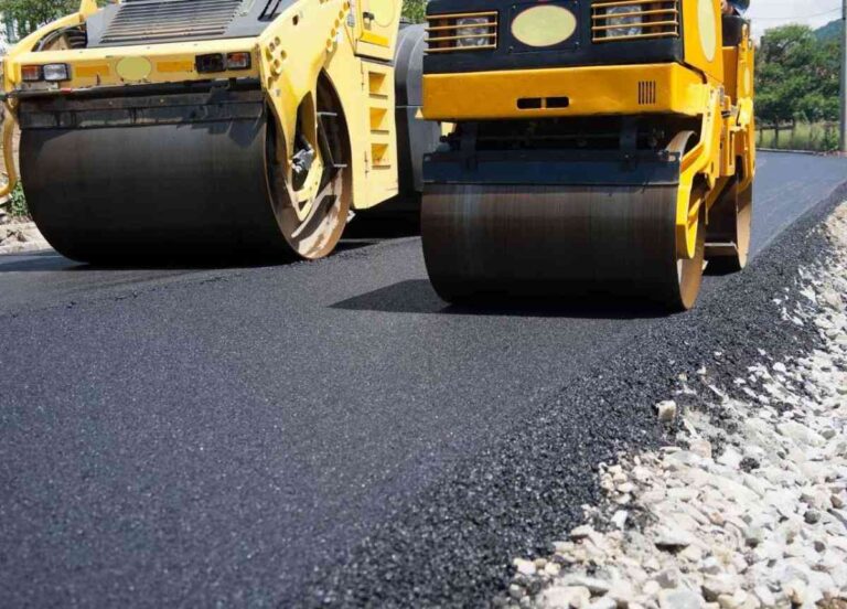 Two small compact rollers side by side compacting the asphalt