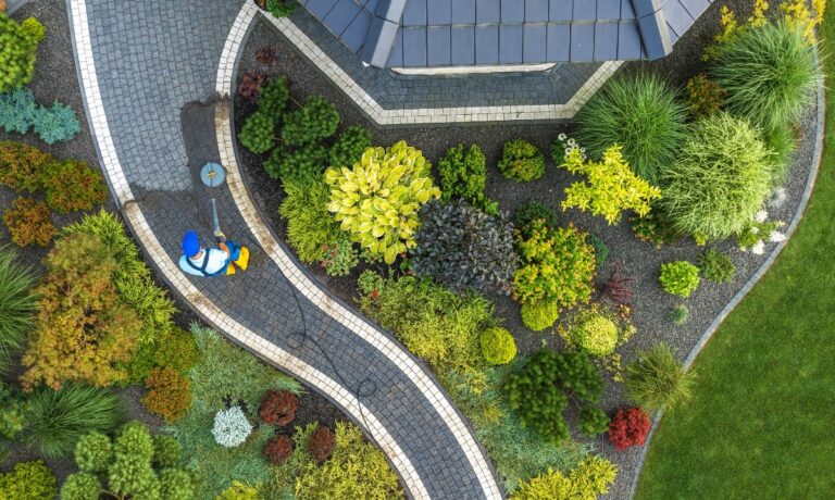 gardener-tending-to-colorful-plants-in-a-well-designed office landscape