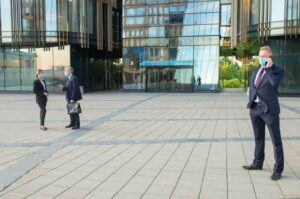 business people standing outside office building 