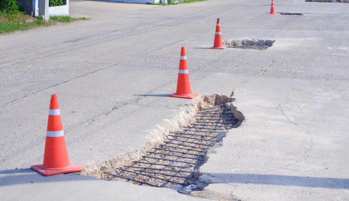 Parking lot with potholes and orange cones