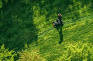 A man moving the grass with lawn mower