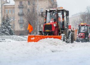 commercial snow removal services by snow trucks shoveling snow