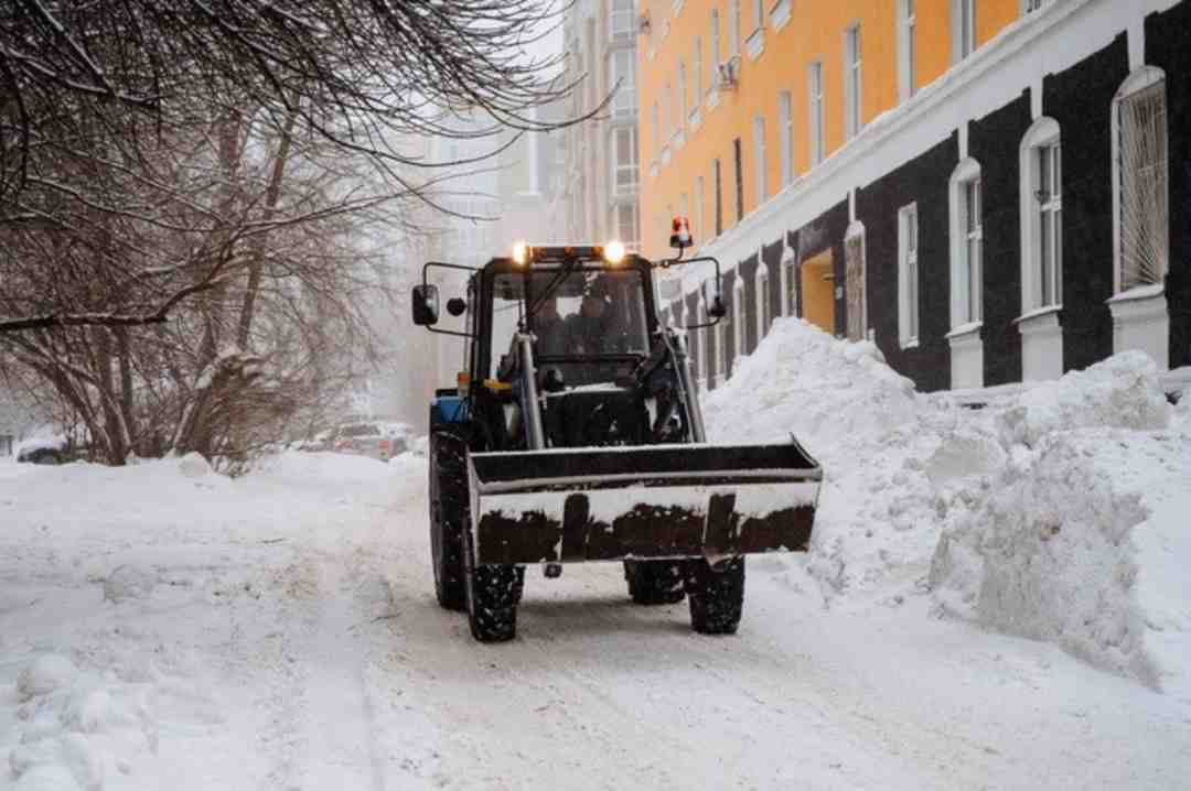 snow removal truck driving down path