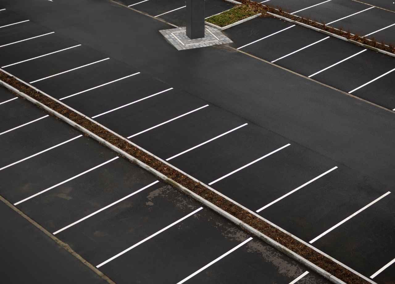 empty striped asphalt parking lot