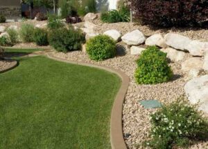 customized designed landscaping with lush lawn and stone works