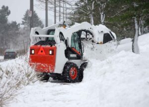 white snow removal truch in snow