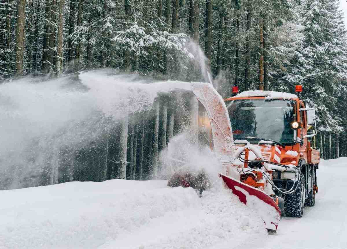 snow removal service using snow road clearing truck