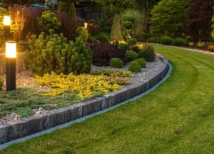 Landscaped lawn with standing decorative lights in garden