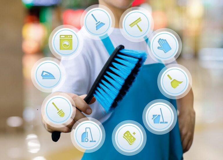 Someone holding a brush with different logo's representing cleaning