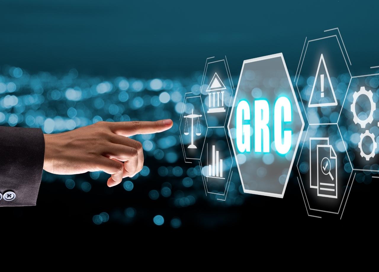 digital compliance, a make hand pressing a virtual GRC screen