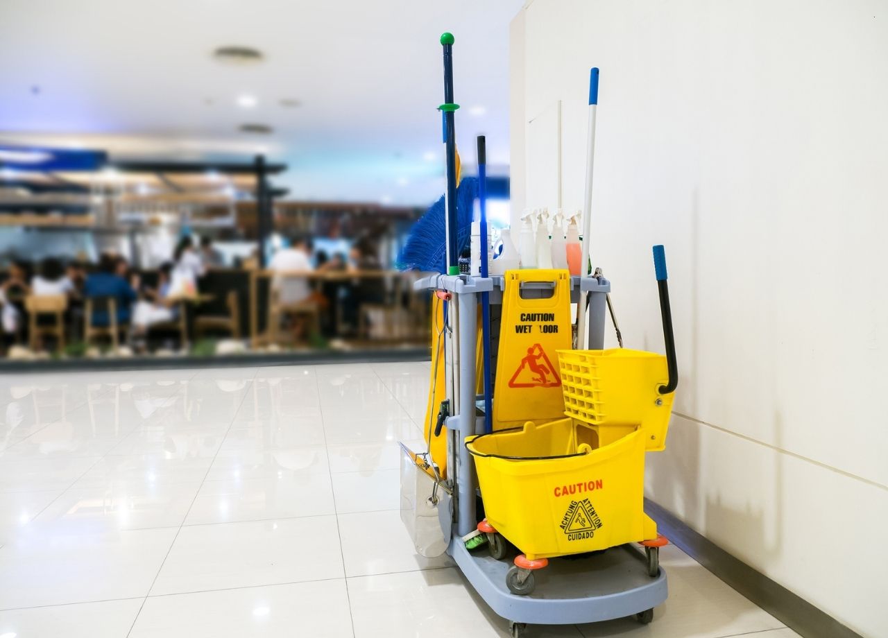 commercial janitorial cart beside office wall.