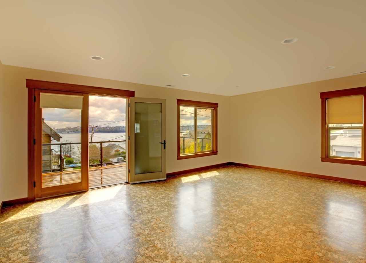 Cork Flooring in an empty house with brown door and window frames