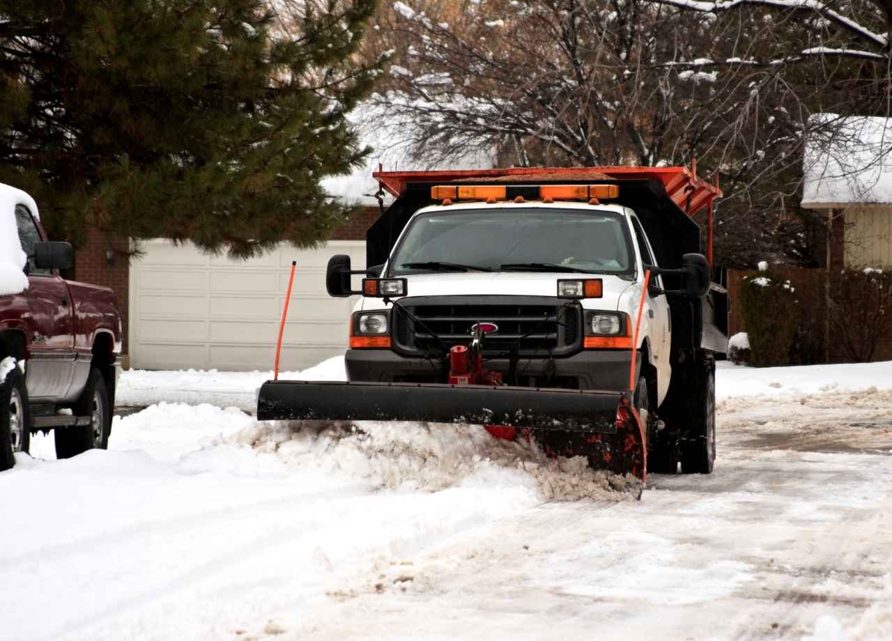 Small truck shoveling snow