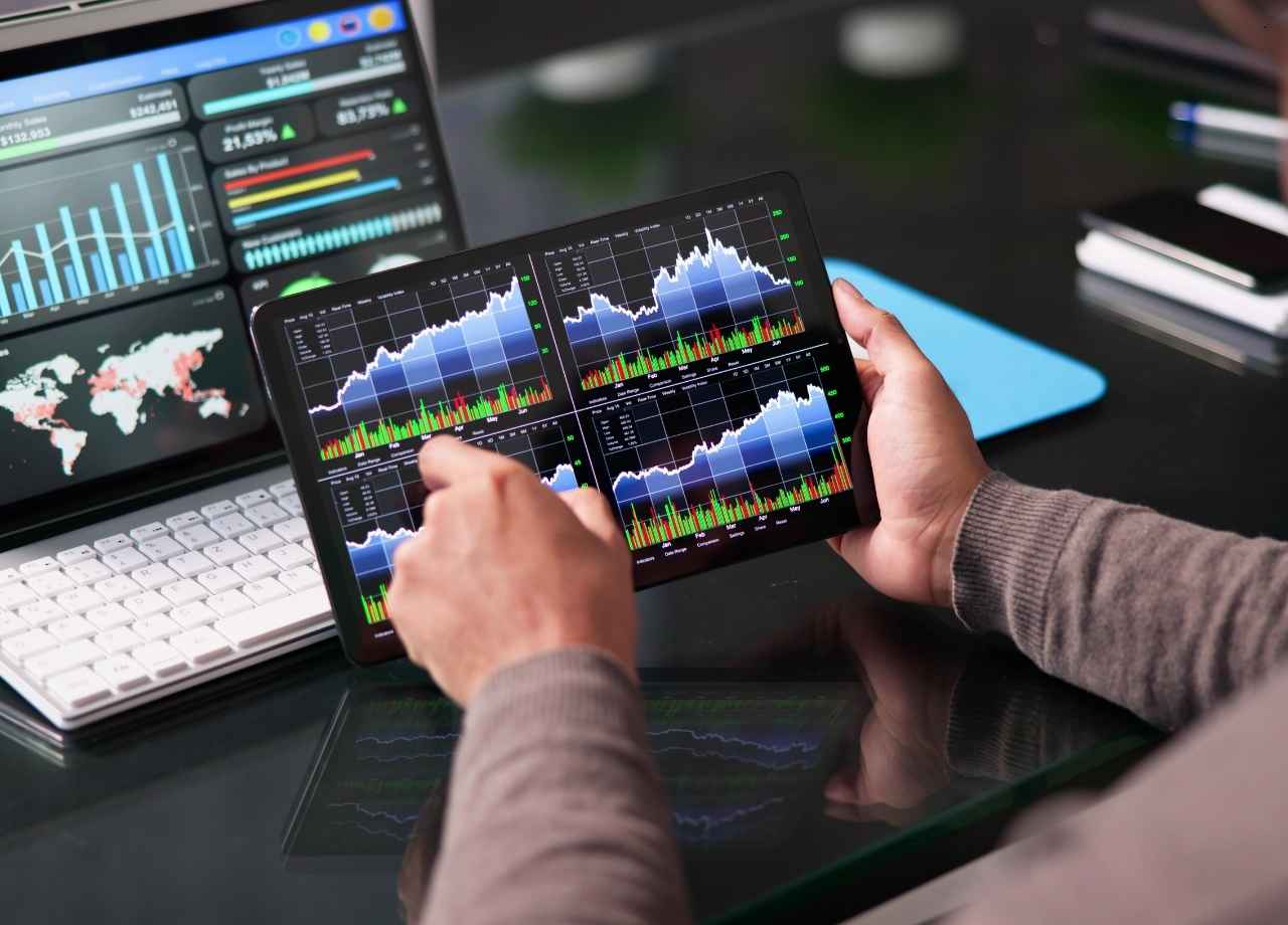 someone holding an ipad with data on it