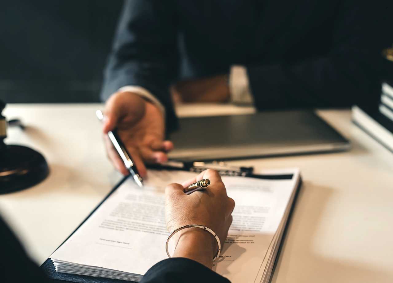 Two business people signing a contract