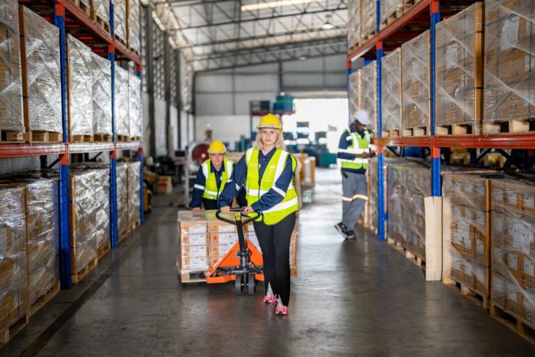 worker-pulling-cardboard-boxes-at-warehouse