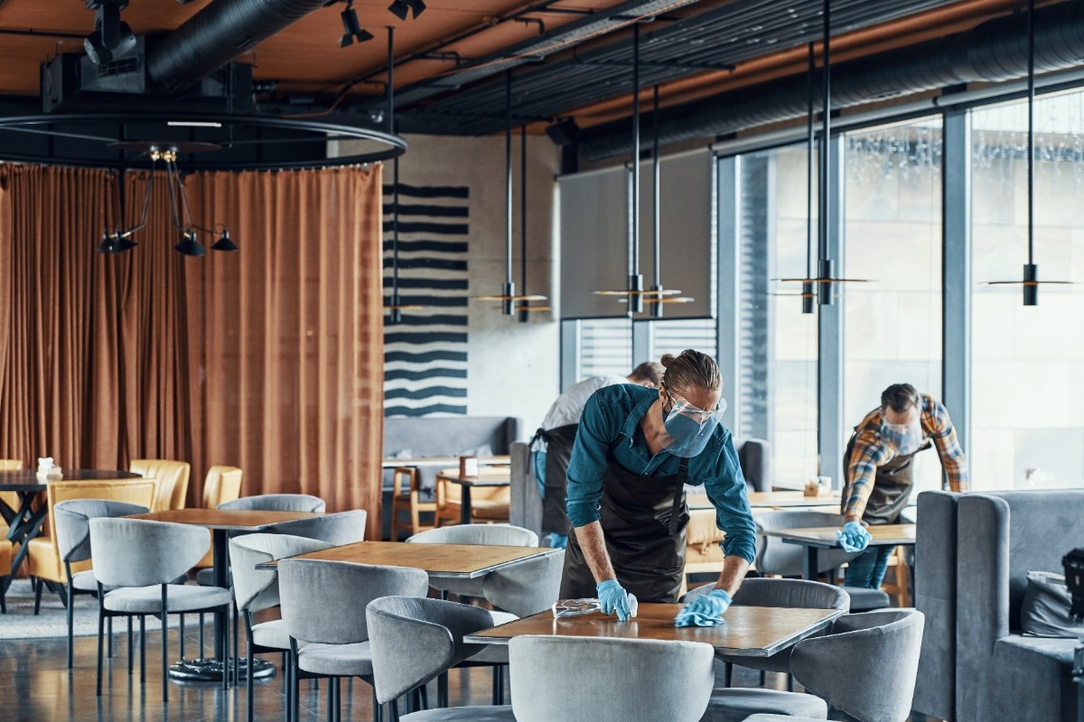 wait-staff-in-protective-workwear-cleaning-tables