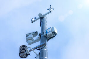 Automatic weather station, with a weather monitoring system and video cameras for observation. Against the background of blue sky clouds